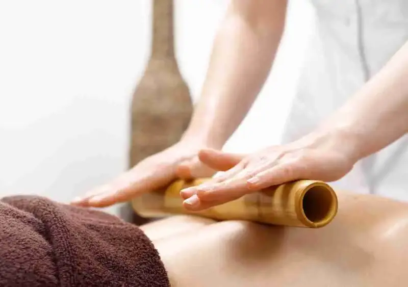 Bamboo Fusion, Bamboo rolling on a clients back on the massage table