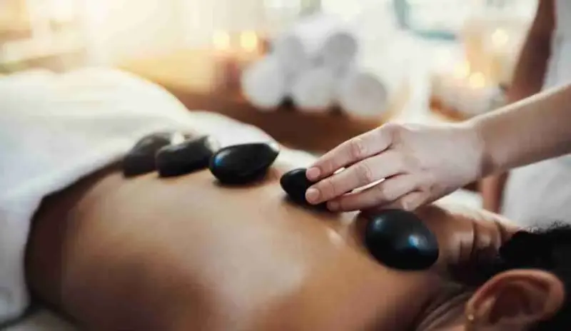 Hot Stones Massage Add on Hot Stones on a Massage clients back during a treatment