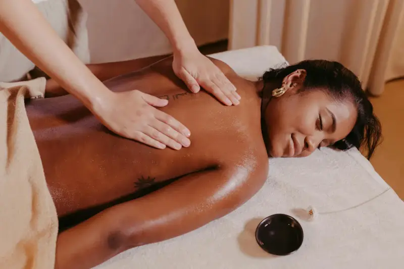Client receiving a Lymphatic Drainage Massage on a massage table