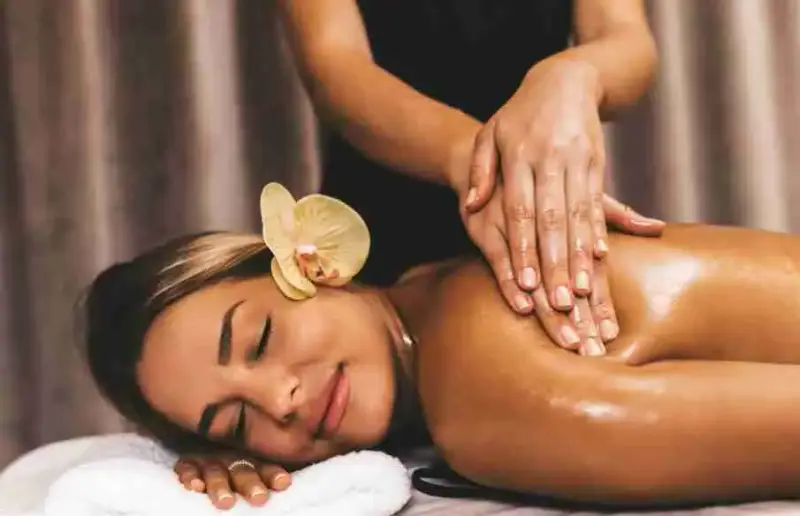 Lady getting a Swedish massage smiling on a massage table